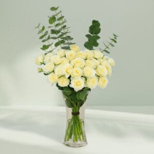 A bunch of Fresh white roses and eucalyptus in a vase for centerpiece