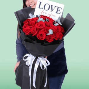 Premium red roses and eucalyptus arrangement in black wrapping with a “Love For You” card