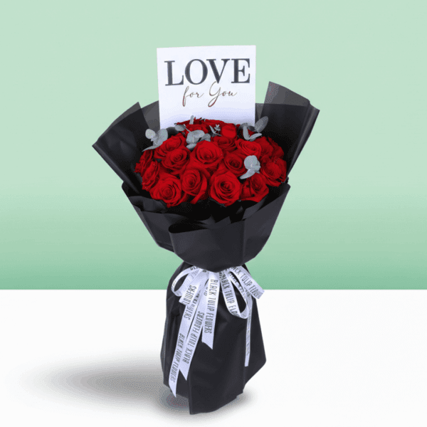 Premium red roses and eucalyptus arrangement in black wrapping with a “Love For You” card